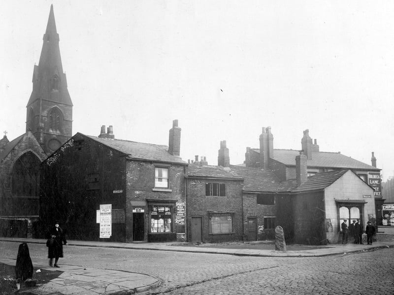 Wortley Lane in September 1931 On the right, St. John the Baptist Church, moving right on gable end of building sign for Spence Lane, poster for Palladium Holbeck. This is the junction with Wortley Lane. Shop with window display and sign for Spratts bird food is no.6, Ernest Coulson corn dealer. To the right no.4 has been Norris Swift, wire worker, then no.2A Harry Beck, clogger.Next is junction with Holbeck Lane.