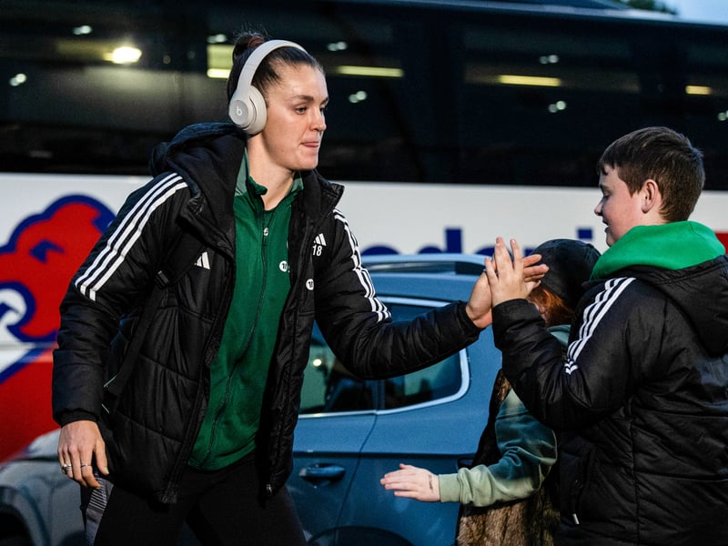 Caitlin Hayes gives a young fan a high five heading into the stadium.