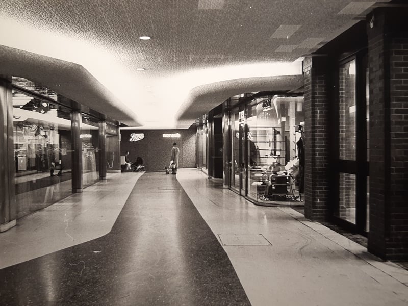 Boots in the distance with a Norweb sign to the right. The display windows of Dorothy Perkins to the left. Which shop is to the right? This was December 1982 at the Houndshill in Blackpool