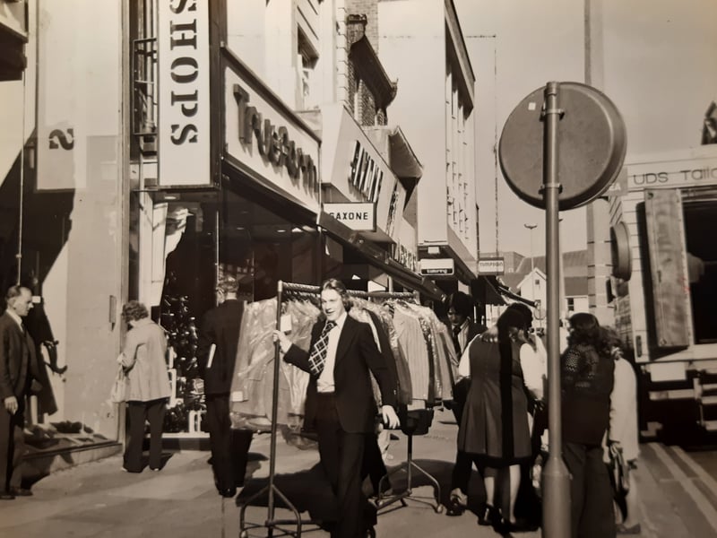 The new pedestrian 'precinct' was causing difficulties for deliveries to shops outside the allotted time in this 1971 photo. The caption reads 'sometimes racks of dresses and suits have to be trundled along the pavement through the crowds'