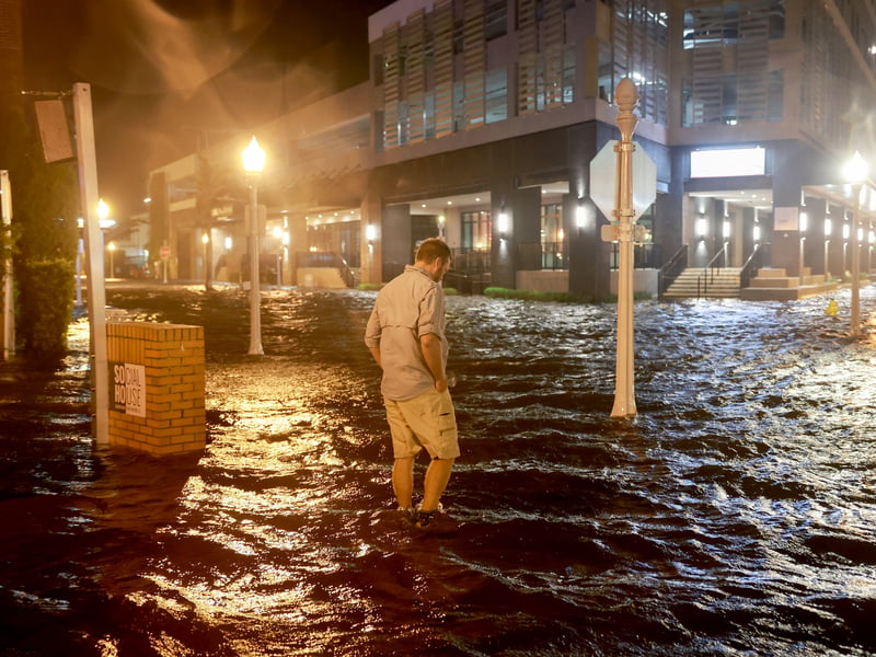Brandon Marlow walks through surge waters flooding the street in Fort Myers, Florida.                         