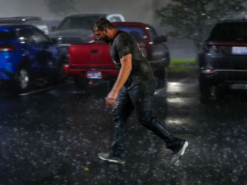 Chris Nation skids on puddles in the parking lot of the hotel where he's riding out Hurricane Milton in Tampa, Florida. Nation works for a towing compan that has been deployed to Florida to aid in the aftermath of the storm.