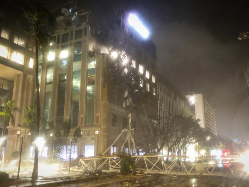 A crane falls onto a building along 1st Avenue South in St. Petersburg, Florida, as Hurricane Milton's strong winds tore through the area.