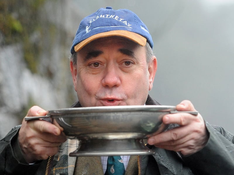 Alex Salmond opens the salmon fishing season on the River Tay near Dunkeld. The First Minister performed the traditional blessing, dousing the boats with whisky to wish them and their passengers well for the coming season. Picture: Neil Hanna/NationalWorld