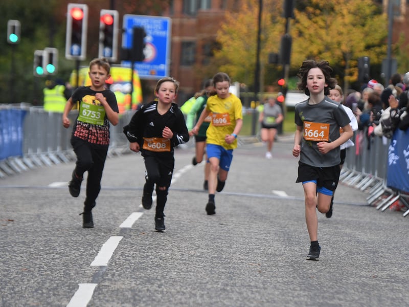 Junior runners arrive at the finish line