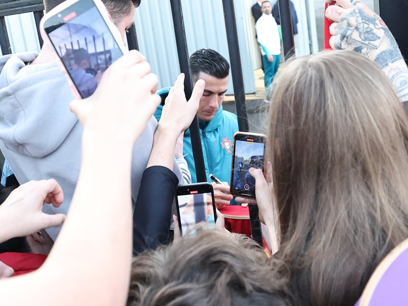 Cristiano Ronaldo signs autographs for fans who gathered at the SMiSA Stadium in Paisley.