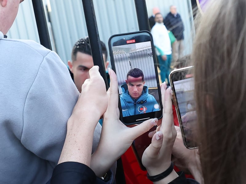Fans take photographs of Cristiano Ronaldo as the Portugal superstar greets them outside the SMiSA Stadium.