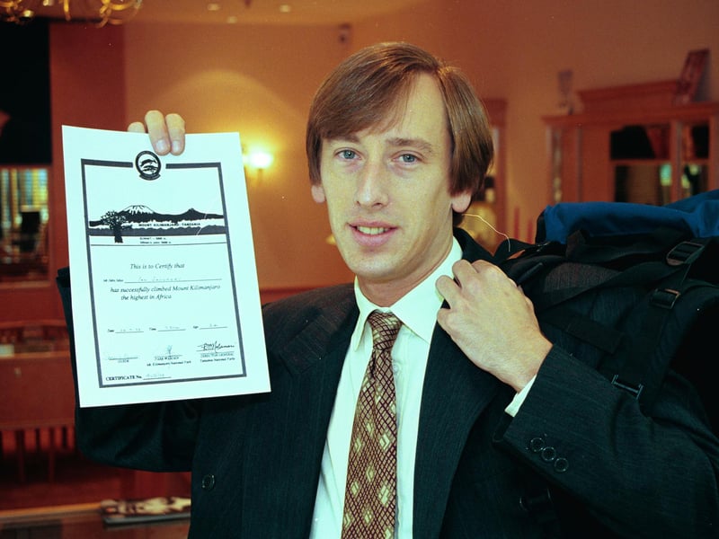 Ian Saunders pictured at Meadowhall, where he works, with his certificate for climbing Mount Kilimanjaro