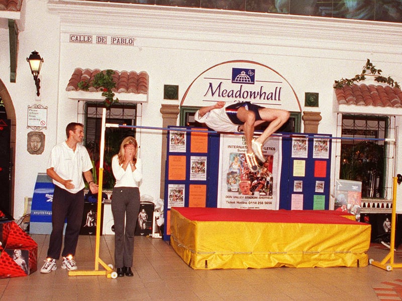 Three-time Commonwealth medallist Geoff Parsons goes for a Fosbury flop style clearance, with Miss Sheffield, Julie Melvin, left, standing under the bar
