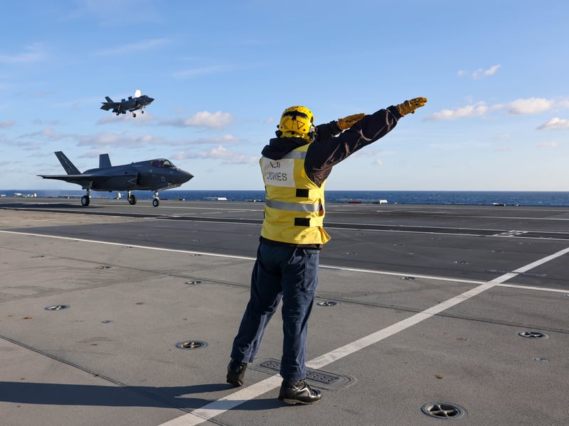 Pictured: Aircraft handler guiding an F-35B prior to landing. Squadrons on HMS Prince of Wales conducting various training exercises on board during the build up to Exercise Strike Warrior.