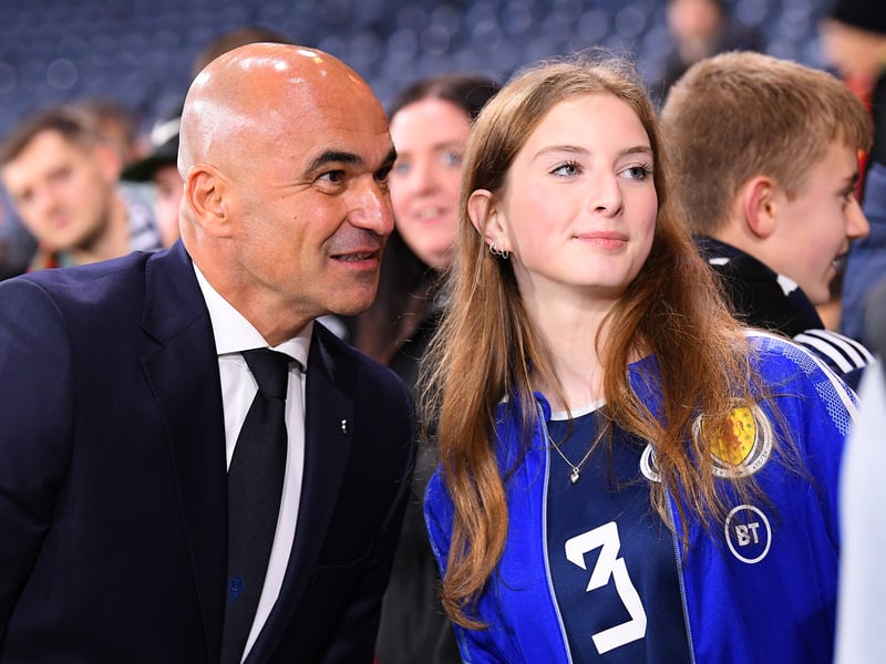 Roberto Martinez poses for a photo with a fan prior to the game.