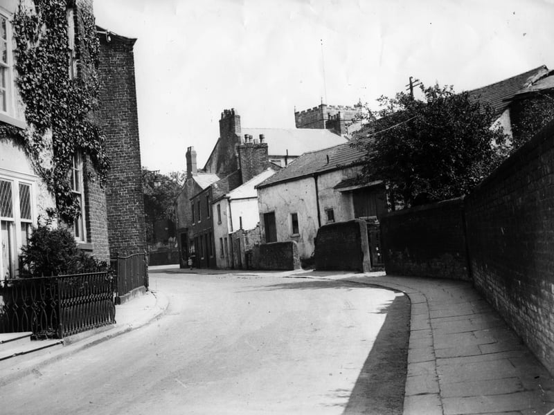 The Old Tithebarn on Tithebarn Street looking towards Ball Street.Through the centuries the church collected payments called tithes and used some of their value to help the sick and needy. Tithe goods like corn were stored in tithebarns such as this which stood on what is now part of the Teanlowe car park