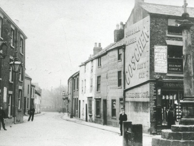 In 1904 the view down Blackpool Old Road from it's junction with Poulton Market Place was very different than today, the old mill building further along on the left and the houses and shops on the right have all given way to road improvement and modern development.
The Bull on the left and building on the right, which was then an ironmongers, advertising a brand of cigarettes which "suits all classes" , remain along with the stocks and the market cross.
