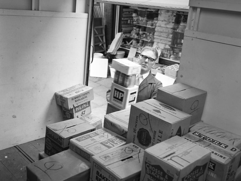 A shopkeeper unloading a delivery of canned food from a lorry in 1962.