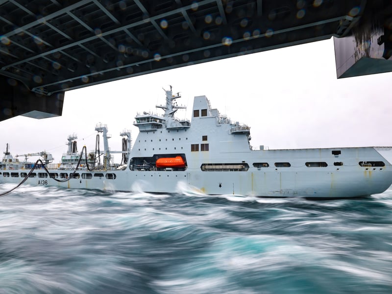 Pictured: RFA Tidespring replenishing HMS Prince of Wales. RFA Tidespring and HMS Prince of Wales conducting a RAS (Replenishment at Sea) in order to take on more fuel.