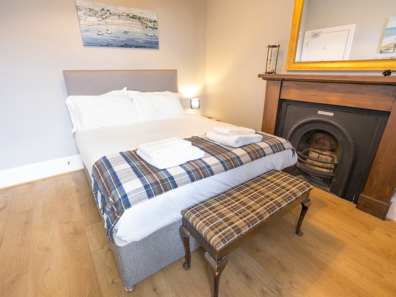 The cosy fireplace in one of the Ness Walk apartment bedrooms.