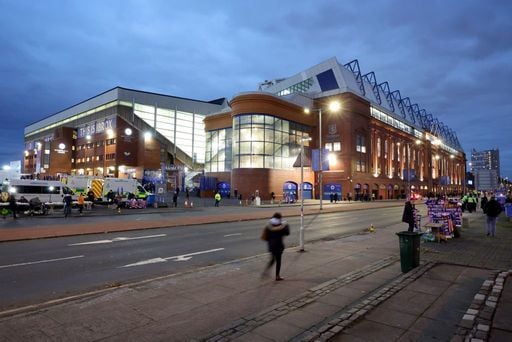 Supporters begin to arrive at Ibrox as the sun sets on the famous stadium.