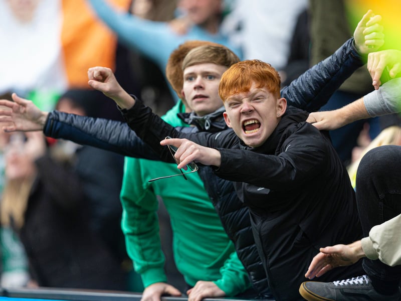 Two young Hibs fans celebrate the opening goal at Easter Road.