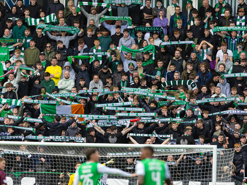 Hibs fans lift their scarves during the 1-1 draw.