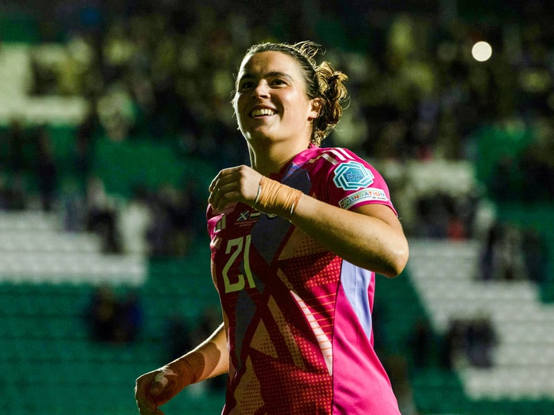 Goalkeeper Eartha Cummings celebrates the win with fans at full-time.