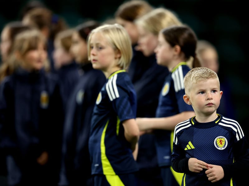 A young Scotland fan prepares to lead the SWNT out on to the Easter Road pitch.