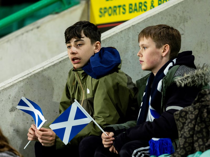 Two young supporters wave their flags ahead of the clash.