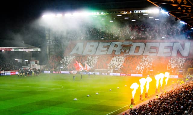 Pyrotechnics at Pittodrie as the Aberdeen and Rangers players emerge from the tunnel ahead of kick-off. (Photo by Rob Casey / SNS Group)