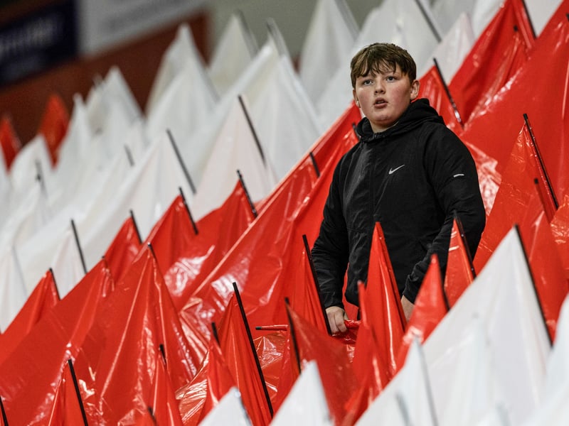 A young Aberdeen fan prepares for kick-off against Rangers at Pittodrie.