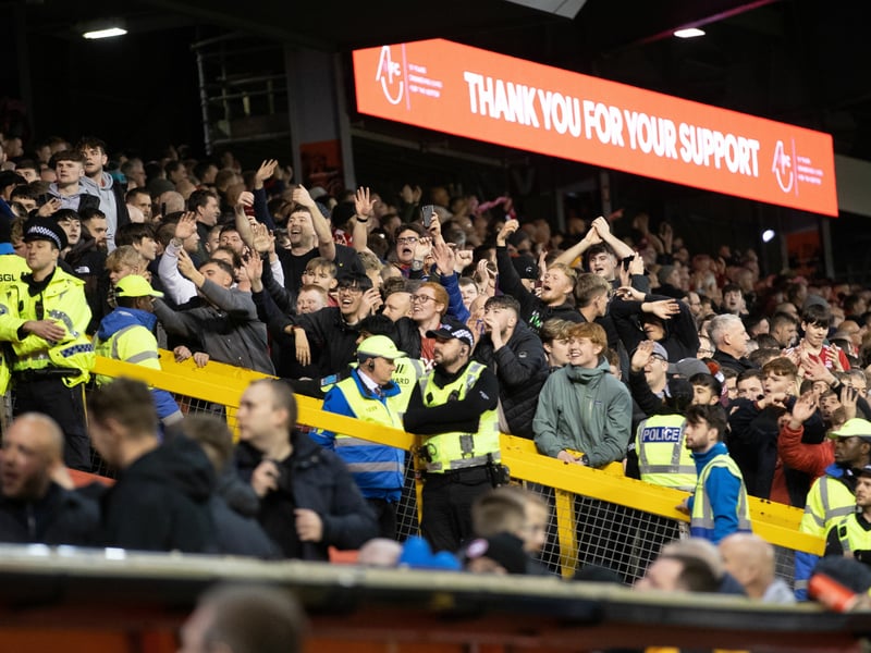 Aberdeen fans celebrate at full-time after securing a mammoth win.