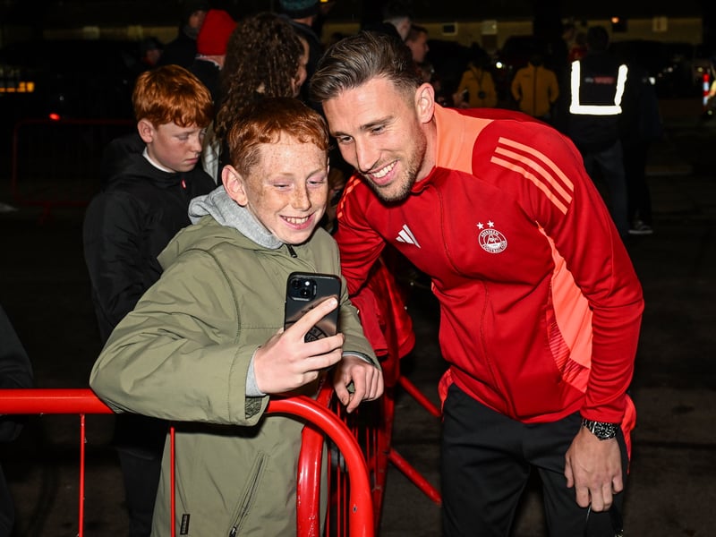 Angus MacDonald poses for a photo with a young fan outside Pittodrie.