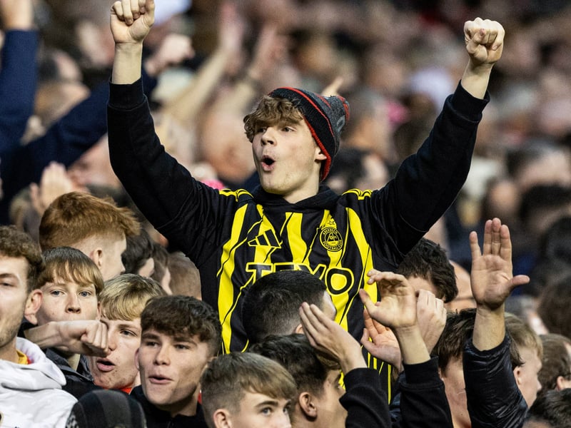 A young Aberdeen fans celebrates a famous victory at Pittodrie.
