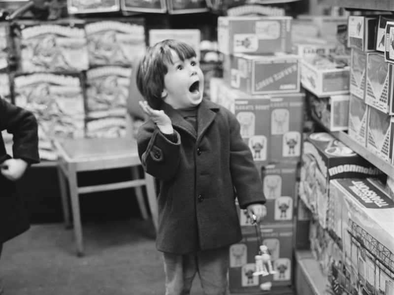 A child shopping in Hamley's toy store on Regent Street at Christmas, UK, December 1971. Hopefully they got plenty of good ideas for Santa's list. 