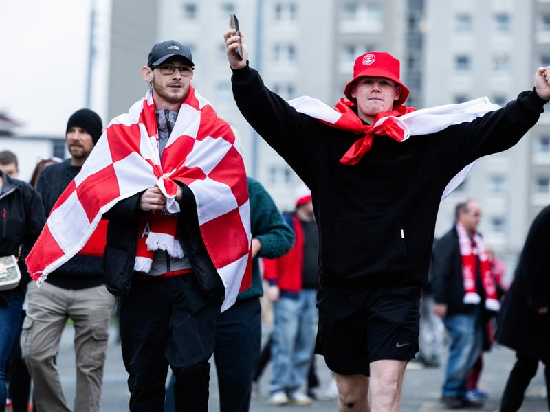Two Aberdeen fans get ready to enter the stadium.