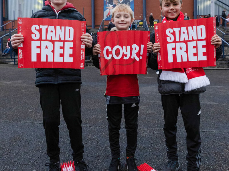 Three young Aberdeen fans show their backing for their team.