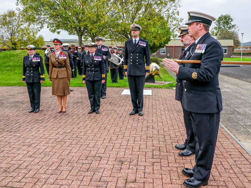 Uniformed and civilian personnel gathered with the Commanding Officer of HMS Sultan, Captain Mark Hamilton, The Commandant of the Defence College of Technical Training (DCTT), Brig Caroline Woodbridge-Lewin MBE and Royal Navy Director People and Training, Rear Admiral Jude Terry OBE at Ceremonial Sunset as the Tri Service flag came down at the Establishment for the last time.
