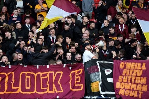 Motherwell fans cheer on their team in the Hampden Park stands.
