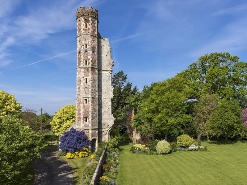 The listing says: "Warblington Castle is a wonderfully unique, stone Manor House, of generous proportions, standing within about 4 acres of beautiful and well-tended gardens that include a swimming pool, outbuildings, a lovely old granary on staddlestones, a vegetable garden, fruit trees and a stunning moat (dry) together with an historic Tower and part of the original Castle gateway." 