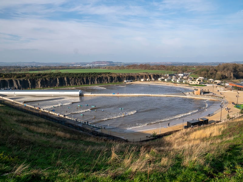 The Lost Shore Surf Resort surveyed from a vantage point. Surfers try out the new wave pool at the launch of the facility in Newbridge, near Edinburgh. Picture: Jane Barlow/PA Wire