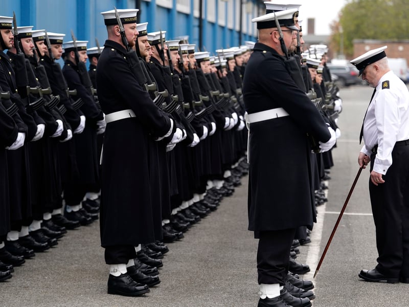 A Royal Navy State Ceremonial Instructor measures the distance between sailors as some of the 104 Royal Navy personnel who will form the the processional group at the National Service of Remembrance make final preparations at HMS Excellent on Whale Island in Portsmouth, Hampshire, for the annual parade and service held at the Cenotaph in London. Picture date: Tuesday November 5, 2024.