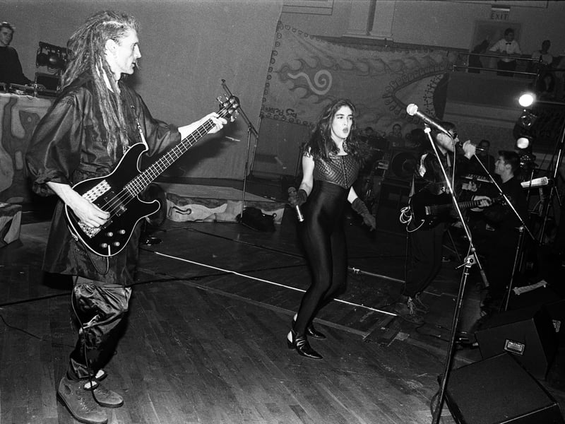 Will Sinnott and Plavka Lonich of The Shamen perform on stage in Aberdeen, the city where the band formed, in 1990. The band, whose lead singer was Colin Angus, were then at the peak of their early powers with the release of their album En-Tact, a linch pin of early UK dance music culture . Will Sinnott tragically drowned in Tenerife shooting a music video for their track Move Any Mountain in 1991. (Photo by Martyn Goodacre/Getty Images).