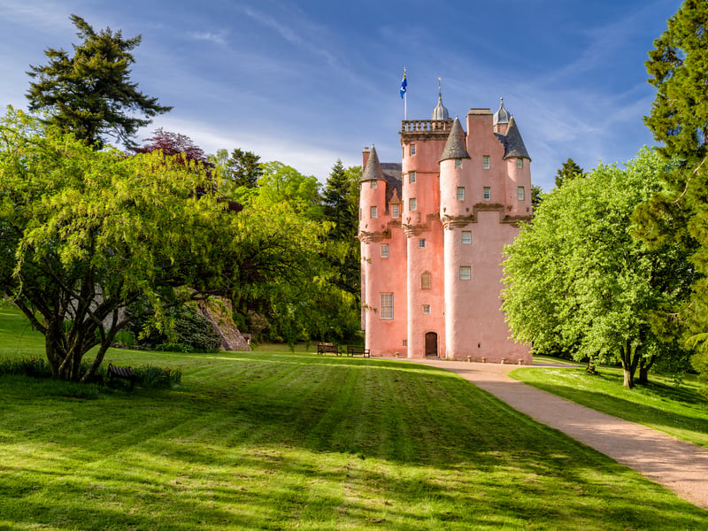 Situated in Aberdeenshire, the bright pink façade of Craigievar Castle is said to have inspired Walt Disney's Cinderella Castle. Surrounded by woodlands, the Baronial style property is packed with history and art. 