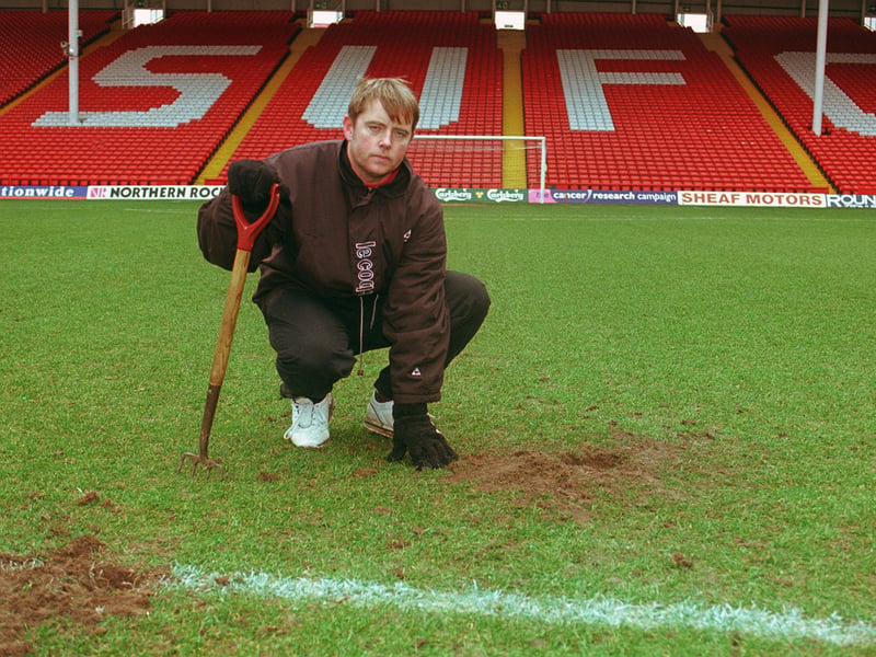 Sheffield United head groundsman Glenn Nortcliffe examines the holes near the centre spot left by a fox intruder in 1999