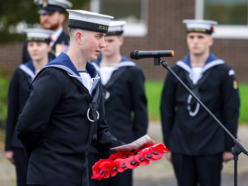 Trainee survival engineering technician, Charlie Burdock, lays a wreath at the ceremony.