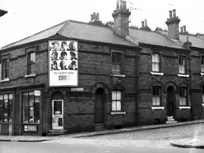 Cambridge Road, on the left is number 21, a grocers shop run by G.Beckwith. Next 23 has early advertisement for Birds Eye frozen foods. At the corner with Claro Place is a poster for Swan Vestas matches. Moving to the right are numbers 1 and 3 Claro Place.