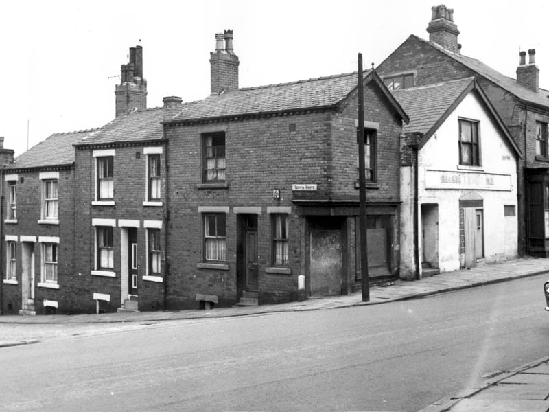 To the left is Servia Grove with number 17, then 19 and 21 on the corner. This had been a shop with window on Servia Road, which has been boarded up. The white building had been a gymnasium. This was the end of Servia Road. The last building on the right was number 136 Oatland Lane.
