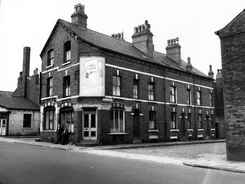 Clayfield Street seen from Cambridge Road, number 18 is left of the shop window, then 16, 14 to the left. Fronting onto Cambridge Road at number 14 is Dons Tattoo Studios. On the left the end of Ashfield Terrace, with Motor supply shop.