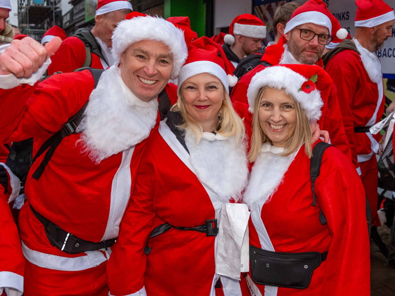 A trio of santas pose