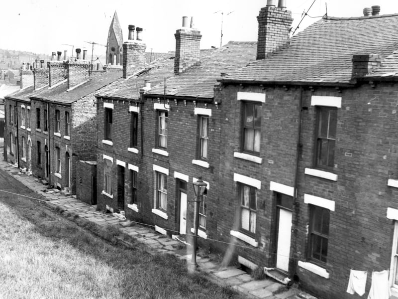Claro View, facing waste ground part of which had been used as a wood yard. The spine of the churchof the Holy Name can be seen at the junction of Servia Road and Cambridge Road. On the left at the bottom of Claro View is access road to Woodhouse Street. The upper boundary was Servia Hill.