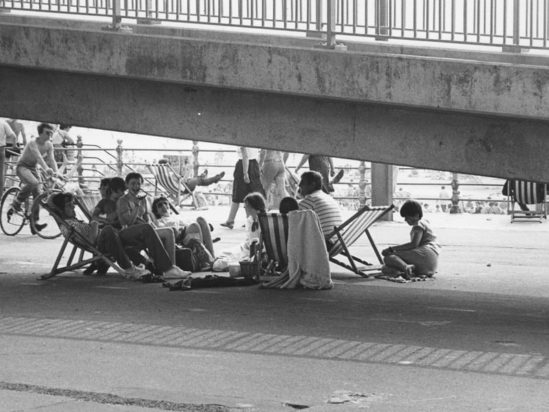 Take the walk bridge over the promenade - and a shelter from the sun