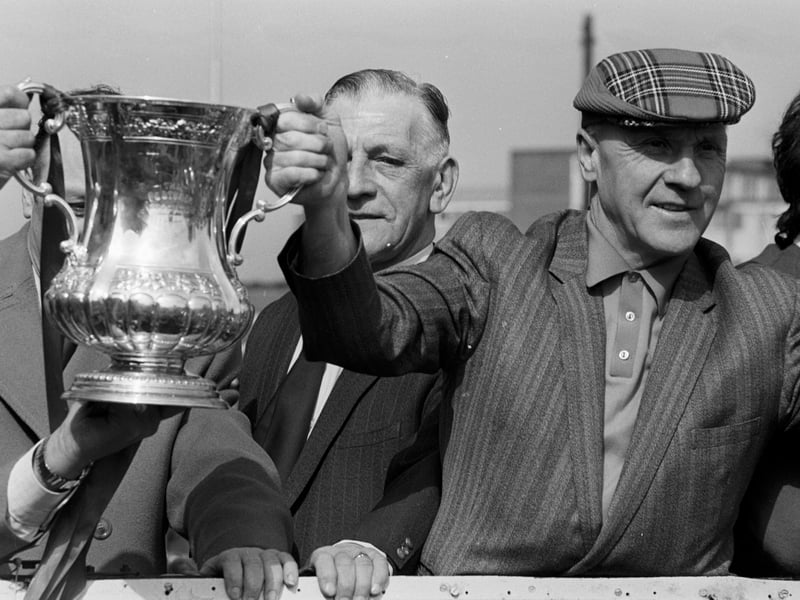Liverpool manager Bill Shankly in tartan cap holds the winning trophy on the Open Top Bus during the Liverpool FC 1974 FA Cup Victory Parade after winning the 1974 FA Cup Final against Newcastle United 3-0.